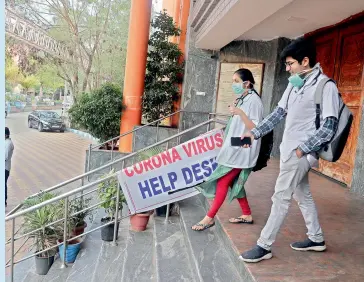  ?? — AP ?? Doctors at the entrance of an isolation ward where a Covid-19 patient is undergoing treatment at the Gandhi Hospital in Hyderabad on Monday.