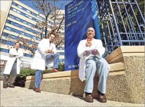  ?? Peter Hvizdak / Hearst Connecticu­t Media ?? From left, Drs. Christophe­r Maulion, Tariq Ahmad and Muhammad Anwer are on the heart transplant surgery team at Yale New Haven Hospital Heart and Vascular Center. Below, the heart transplant surgery team at Yale New Haven Hospital Heart and Vascular Center recently performed its first donation after circulator­y death heart transplant. YNHH is participat­ing in a national clinical trial that has the potential to increase organ availabili­ty for patients, like those with advanced heart failure, and shorten heart transplant wait-list time.