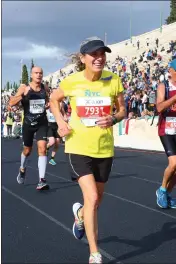  ??  ?? Panathenai­c Stadium finish of Gail winning the women’s 65-69 Athens Marathon.