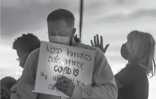  ?? STEVE GRIFFIN/THE DESERET NEWS ?? Family members of inmates in the Utah prison system say a prayer Oct. 13, 2020, after a rally outside the Department of Correction­s office in Draper.