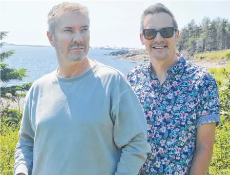  ?? CHRIS CONNORS • CAPE BRETON POST ?? Internatio­nally celebrated interior designers Justin Ryan, left, and Colin McAllister stand on the grounds of the Point of View Suites in Louisbourg. The couple plans to remodel the scenic seaside retreat and relaunch it as North Star.