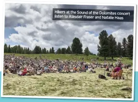  ??  ?? Hikers at the Sound of the Dolomites concert listen to Alasdair Fraser and Natalie Haas