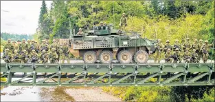  ?? SUBMITTED PHOTO ?? U.S. National Guard and Canadian combat engineers worked shoulder-to-shoulder on a bridge constructi­on project at the 5th Canadian Division Support Base Gagetown during Exercise Strident Tracer 2017.