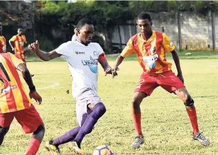  ?? KAVARLY ARNOLD ?? Andre Tate of Irwin High School trying to dribble his way past Calvin Gardener of Cornwall College in their ISSA/WATA daCosta Cup encounter at the Cornwall playing field in Montego Bay yesterday.