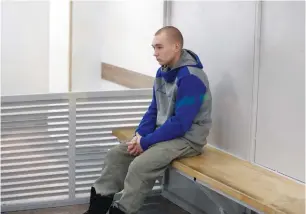  ?? (Viacheslav Ratynskyi/Reuters) ?? RUSSIAN SOLDIER Vadim Shishimari­n, 21, sits inside a cage during a war crimes trial in Kyiv yesterday.