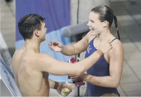  ??  ?? 0 Grace Reid is all smiles as she celebrates with partner Ross Haslam. The pair won silver in the three-metre mixed synchro diving event.