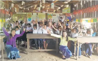  ?? PHOTO: SUPPLIED ?? Bright future . . . Cambodian children and their teachers with Julie CarlawHill­ary, (centre front) of Queenstown, inside the school she and her husband, Mark Hillary, upgraded. The couple has also built a new school in Ou Ambel Village, near Siem Reap, which will be finished next month.