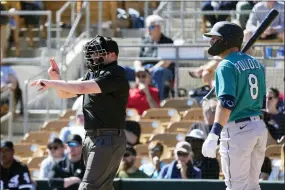  ?? ROSS D. FRANKLIN — THE ASSOCIATED PRESS ?? Home plate umpire Paul Clemons, left, calls a pitching clock violation against Chicago White Sox relief pitcher Reynaldo Lopez as Seattle Mariners’ AJ Pollock (8) looks on during the third inning of a spring training baseball game Monday, Feb. 27, 2023, in Phoenix.