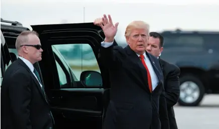  ?? AP PHOTO ?? U.S. President Donald Trump waves as he arrives to board Air Force One at Palm Beach Internatio­nal Airport on Monday in West Palm Beach, Fla., to return to Washington.