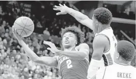  ?? ANDY LYONS/GETTY IMAGES ?? Alabama’s Collin Sexton drives to the basketball by an Auburn defender during the quarterfin­als of the SEC Tournament.