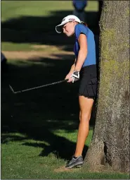  ?? NWA Media/BEN GOFF • @NWABenGoff ?? Brooke Matthews of Rogers High chips Aug. 13 from a difficult ball placement beside a tree on hole No. 5 during a golf meet with Siloam Springs at Lost Springs Golf Course in Little Flock.