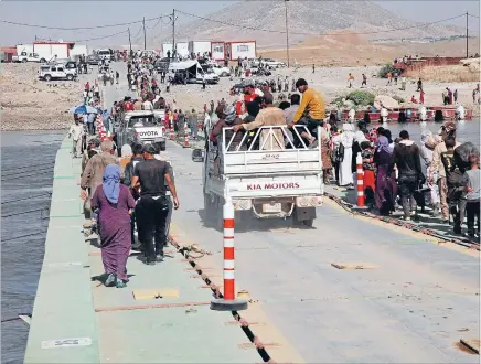  ?? Photo: REUTERS ?? On the march: Displaced people from the minority Yazidi sect, fleeing the violence in the Iraqi town of Sinjar yesterday. Islamic State militants have killed hundeds of Iraq’s minority Yazidis, burying some of them alive and taking women as slaves.