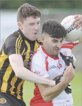  ??  ?? Fearghal Mulholland of Na Piarsaigh tackles Kevin Hearty, St. Bride’s, during the Group B IFC match in Stabannon.