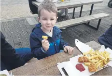  ?? ?? Luke Whitehead, three, enjoying his chips.