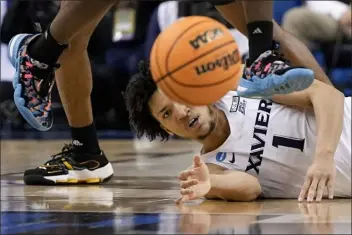  ?? CHRIS CARLSON — THE ASSOCIATED PRESS ?? Xavier guard Desmond Claude eyes a loose ball during the second half of a first-round college basketball game against Kennesaw State in the NCAA Tournament on Friday, March 17, 2023, in Greensboro, N.C.