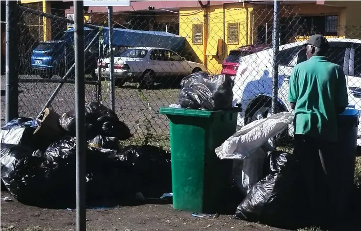  ?? Photo: Kathrin Krishna ?? Bottle and can collector going through rubbish left outside by business houses in Tukani Street in Lautoka.