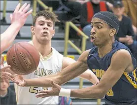  ??  ?? Carrick’s Imuri Walker tries to grab the ball from Highlands’ Luke Cochran in a second-round PIAA game. Carrick ended the season with a 20-6 record after losing to Highlands.