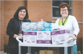  ?? DAX MELMER ?? Windsor Regional Hospital’s Cristina Naccarato, left, manager of philanthro­py, and Monica Stanton, director of guest services, collect medical supplies donated by the public and institutio­ns on Friday.