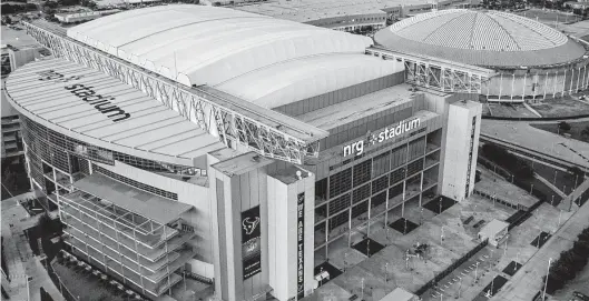  ?? Staff file photo ?? NRG Stadium, foreground, has a capacity of 71,995. While it is not large enough to host a semifinal round match, NRG is suitable for early rounds.