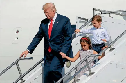  ?? PHOTOS: REUTERS ?? President Donald Trump, with his grandchild­ren Arabella Kushner and Joseph Kushner, arrives aboard Air Force One for a summer vacation at his Bedminster estate in New Jersey.