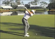  ?? Mike Ehrmann / Getty Images ?? Rory McIlroy plays his shot from the 17th tee during practice rounds Wednesday before The Players Championsh­ip at TPC Sawgrass.