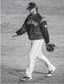  ?? Godofredo A. Vásquez / Staff photograph­er ?? Gerrit Cole takes a fifth-inning stroll to the bullpen, where he remained while the Astros squandered their 2-0 advantage.