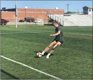  ?? JOHN KAMPF — THE NEWS-HERALD ?? Members of the Mentor football team do stretching exercises on June 8at Jerome T. Osborne Stadium.
Alleilgh Stout of the Mentor soccer team rifles a shot into the net on the first day of workouts on June 8.