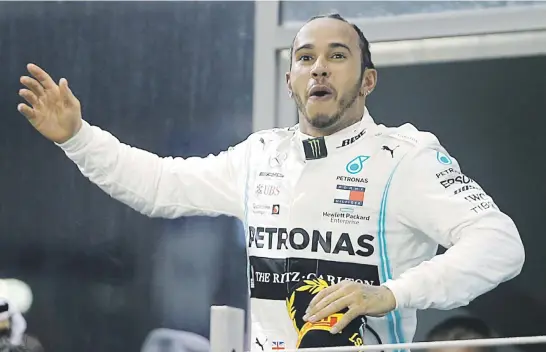  ?? Picture: Reuters ?? CHERRY ON TOP. Mercedes’ Lewis Hamilton celebrates after winning the Abu Dhabi Formula One Grand Prix at the Yas Marina Circuit yesterday.