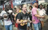  ?? AFP ?? People play music before boarding the Samba Train, the annual special train to carry samba musicians and enthusiast­s to the Oswaldo Cruz neighborho­od, part of celebratio­ns of the national samba day.