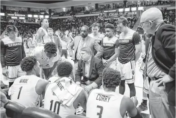  ?? MIKE CAUDILL/FREELANCE FILE ?? Old Dominion head coach Jeff Jones, center, talks with his team during a timeout at Chartway Arena on Jan. 20. The Monarchs return three starters, including leading scorer Malik Curry.