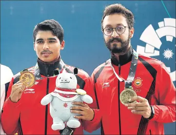  ?? AP ?? ■ Saurabh Chaudhary (left) and Abhishek Verma with their gold and bronze medals in 10m air pistol at the Asian Games on Tuesday.