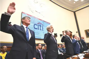  ??  ?? In this file photo taken on April 10, 2019 Citigroup Chief Executive Officer Michael Corbat(L),JP Morgan Chase & Co. Chairman & Chief Executive Officer James Dimon (second left) and others are sworn in before they testify before the House Financial Services Committee on accountabi­lity for mega banks in the Rayburn House Office Building on Capitol Hill in Washington, DC. — AFP photo