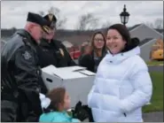  ??  ?? Officers deliver a holiday meal to the home of Linsay Fox, widow of fallen Plymouth Township Police Officer Brad Fox.