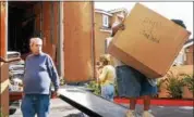  ?? RICH PEDRONCELL­I — THE ASSOCIATED PRESS FILE ?? Glenn Cockrell, left, watches mover Mario Huerta carry a box into Cockrell’s two bedroom townhouse apartment he rented in Sacramento, Calif., Wednesday, Oct. 20, 2004.