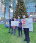  ?? COURTESY OF MACEY REED ?? A group of people stands outside of the Phoenix Children's Hospital with a fund check donated by Peter Piper Pizza on Monday.