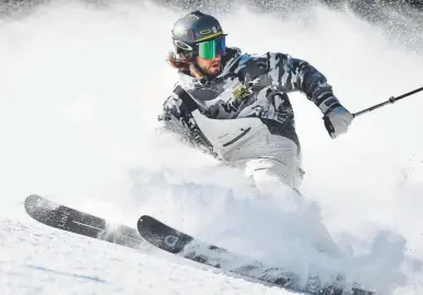  ?? Andy Cross, Denver Post file ?? A skier sends snow flying on a trick coming down the High Noon run on opening day at Arapahoe Basin ski area.