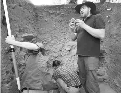  ??  ?? File photo of Clarkson examining a stone tool during excavation­s at the Madjedbebe site.