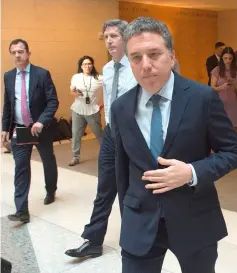  ??  ?? Argentina’s Economy Minister Nicolas Dujovne walks with staff after speaking to the press after talks with the Internatio­nal Monetary Fund (IMF) in Washington, DC. — AFP photo