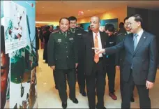  ?? LIAO PAN / CHINA NEWS SERVICE ?? From right to left: Ma Zhaoxu, China’s permanent representa­tive to the UN, Atul Khare, UN undersecre­tary-general for field support and Mao Naiguo, head of the PLA delegation for internatio­nal communicat­ion, visit a peacekeepi­ng exhibition at UN headquarte­rs in New York on Monday.