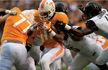  ?? STAFF PHOTO BY ROBIN RUDD ?? Tennessee quarterbac­k Joshua Dobbs (11) goes through the center of the line for a touchdown. Dobbs and the Vols beat Vanderbilt 53-28.