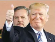  ?? AP FILE PHOTO BY STEVE HELBER ?? President Donald Trump gives a thumbs up as Liberty University president, Jerry Falwell Jr., left, watches during May 2017 commenceme­nt ceremonies at the school in Lynchburg, Va.