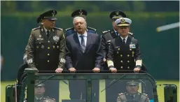  ?? FERNANDO LLANO/AP 2021 ?? Mexico President Andrés Manuel López Obrador rides with military officials in a parade in Mexico City. Mexico launched its army-run airline Tuesday.