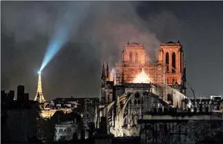  ?? VERONIQUE DE VIGUERIE/GETTY-AFP ?? Smoke and flames rise from Notre Dame Cathedral in Paris in April. A fire broke out and quickly spread across the building, collapsing the spire.