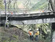  ?? David Royal Monterey Herald ?? ENGINEERS inspect damage to the Pfeiffer Canyon Bridge in Big Sur. The bridge will have to be replaced.