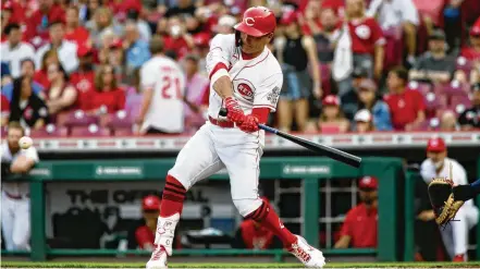  ?? DAVID JABLONSKI / STAFF ?? Cincinnati Reds first baseman Joey Votto singles underwent left rotator cuff surgery last August, and recovery time was set at six months. He still might not be fully recovered as spring training opens.