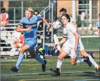  ?? JAMES BEAVER — FOR MEDIANEWS GROUP ?? North Penn’s Josh Jones (23) chases a ball down alongside Central Bucks West’s James Lutz (5) during a game Tuesday afternoon at North Penn High School.