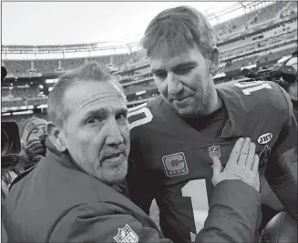  ?? MARK LENNIHAN/AP PHOTO ?? New York Giants interim head coach Steve Spagnuolo, left, hugs quarterbac­k Eli Manning after Sunday’s 18-10 win over Washington at MetLife Stadium. Spagnuolo interviewe­d Wednesday for the team’s head coaching job.