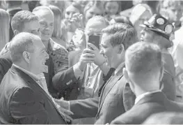  ?? CHRIS URSO/TAMPA BAY TIMES ?? Ron DeSantis, as Florida governor-elect, thanks supporters, including Lev Parnas, of Boca Raton, while Parnas’ partner Igor Fruman takes a photo, on election night in 2018.