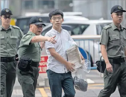  ?? / J. FAVRE (EFE) ?? ENTREVISTA AL LÍDER ESTUDIANTI­L DE HONG KONG: “ESTAMOS DE VUELTA”. Joshua Wong, líder del Movimiento de los Paraguas en Hong Kong, quedó ayer libre tras tres meses en prisión, coincidien­do con las nuevas y masivas protestas. Wong se mostró escéptico sobre la posible dimisión de la ministra Lam. “Sea quien sea que ocupe el cargo será una marioneta de Pekín”, dijo a EL PAÍS.