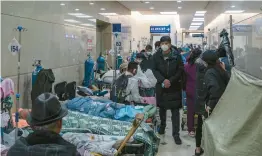  ?? QILAI SHEN/THE NEW YORK TIMES ?? Patients line a hallway Jan. 7 at a hospital in Shanghai. Beijing has greatly increased the official death toll from China’s current COVID-19 outbreak.